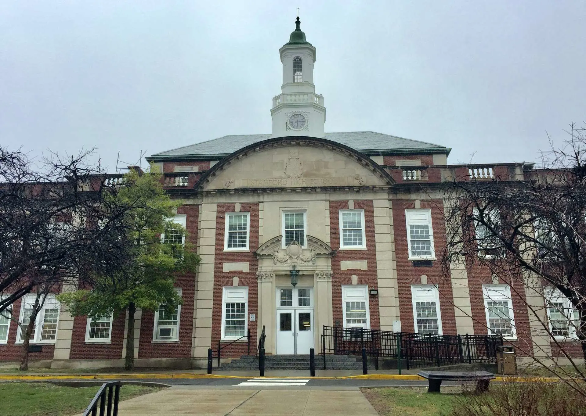 Front view of Stamford High School building with a clock tower.