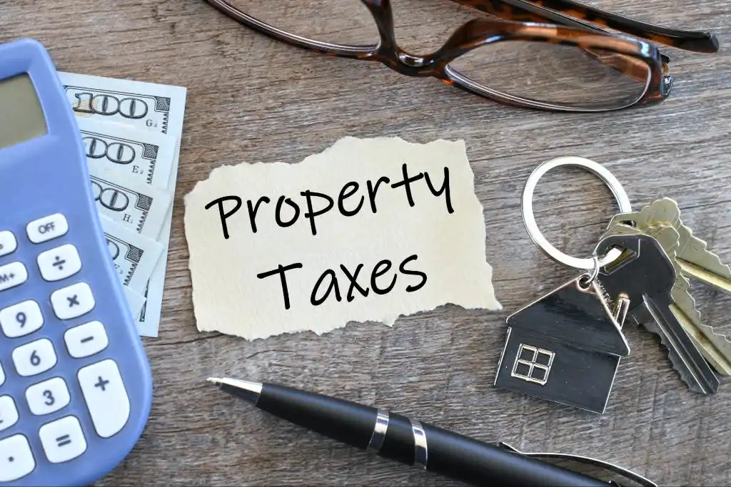 Property tax written on a piece of paper, calculator placed on the side